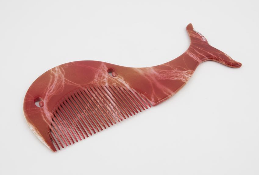 Plastic comb in form of whale, two piercings for eyes