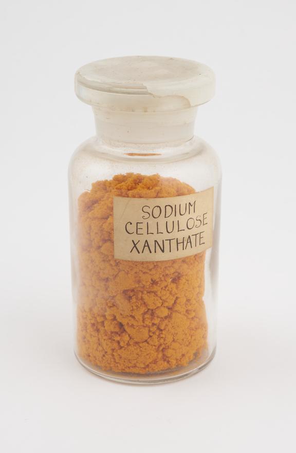 Glass bottle of  soldified sodium cellulose xanthate, orange