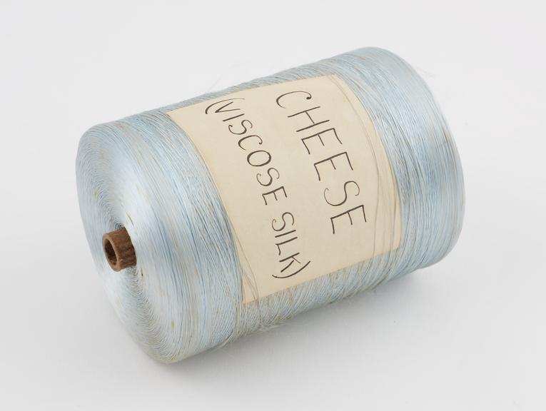 Pale blue spool of vicose.  Labelled  CHEESE (VISCOSE SILK)''