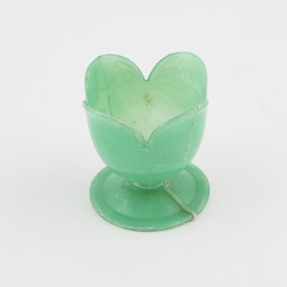 Apple green moulded polystyrene egg-cup, petal shaped rim