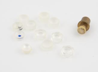 Plastics componenets showing the stages in cutting and polishing soft contact lenses