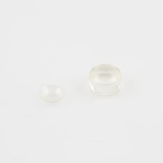 Plastics componenets showing the stages in cutting and polishing soft contact lenses