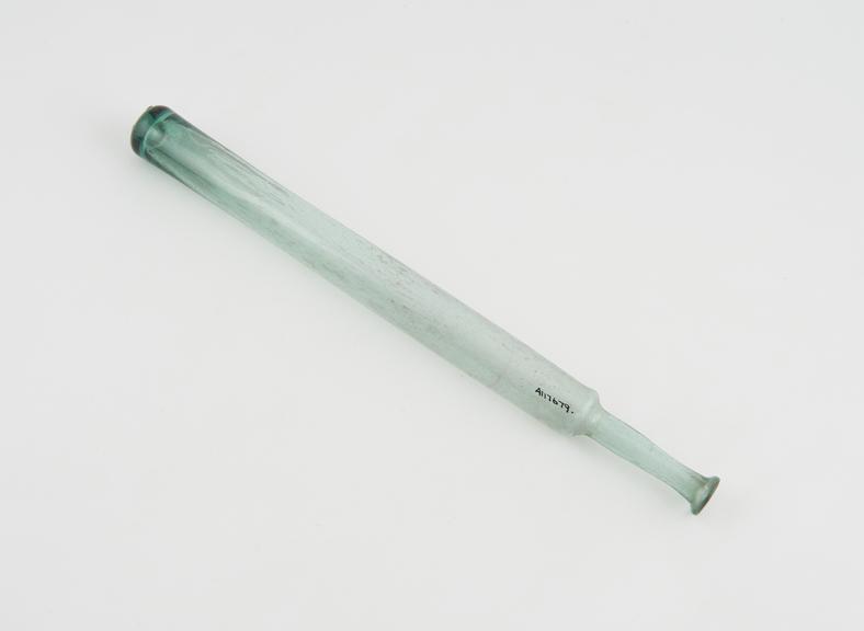 Green glass phial elongeated cylindrical shape