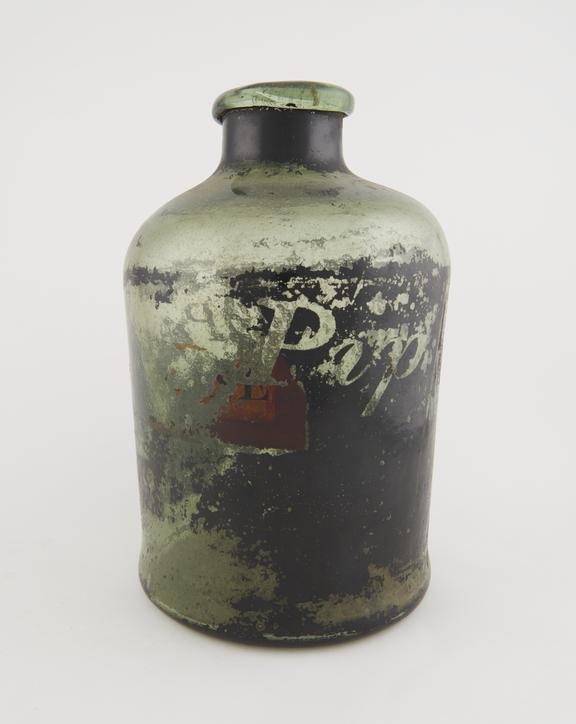 Storage bottle, green glass, label badly obscured