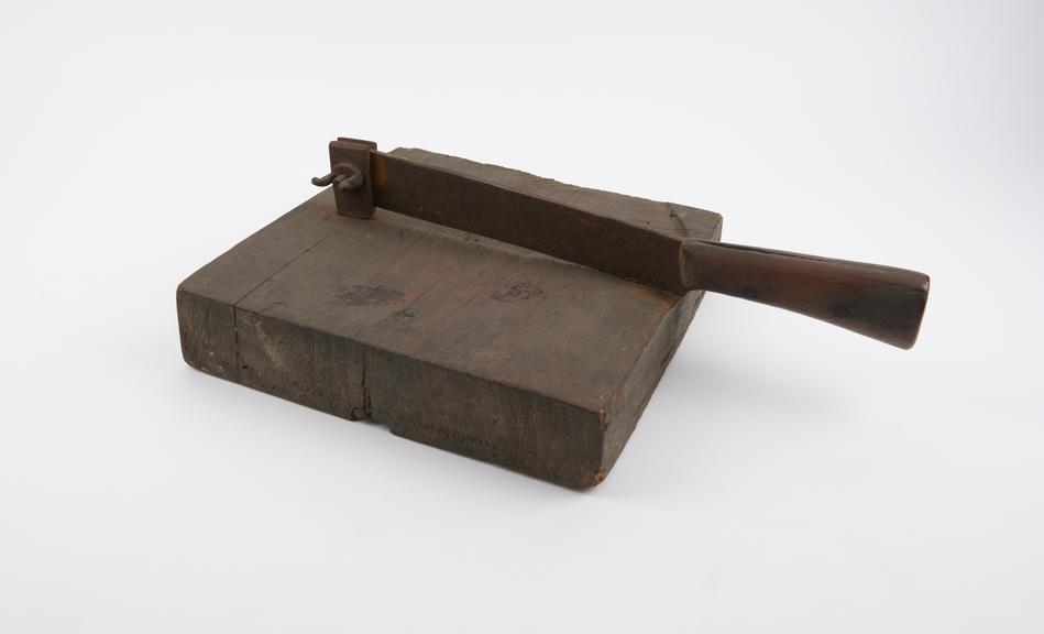 herb cutter, square wooden block with iron blade pirated at end