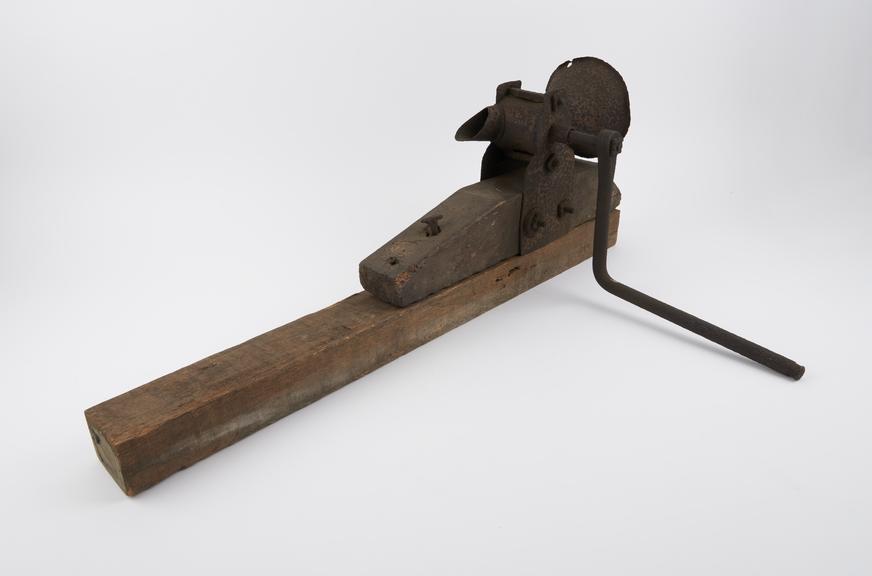 Mill, iron, mounted on wooden pillar, probably English