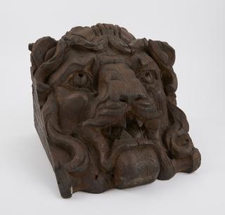 Carved wooden lion face