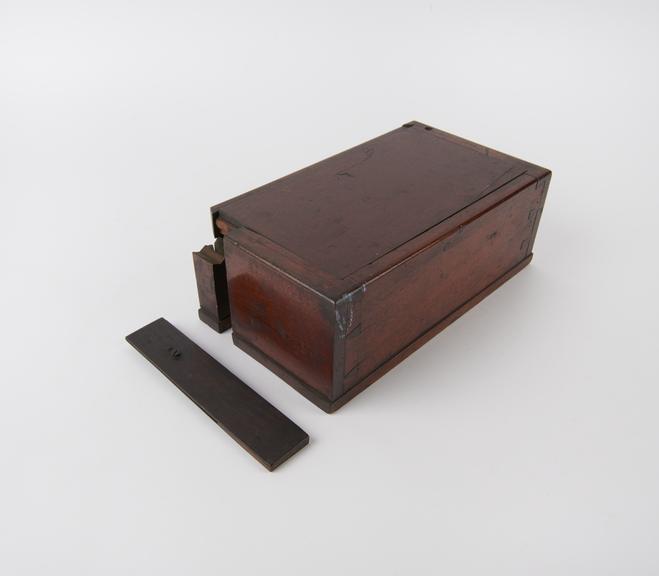 Mahogany case containing parts of crudely made microscope