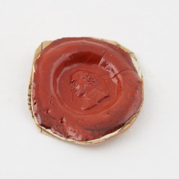 Oval seal with red stamp showing head of Shakespeare in left