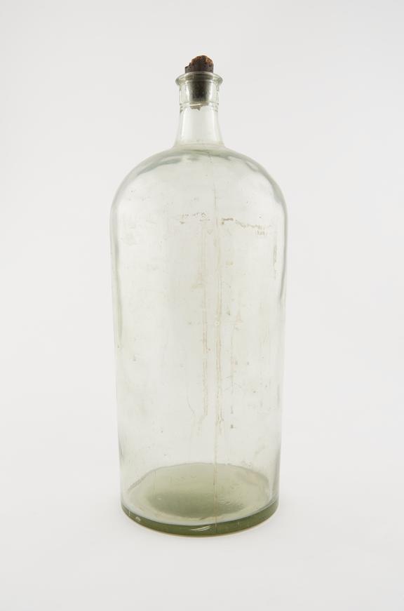 Large Winchester storage bottle, empty, pale green glass