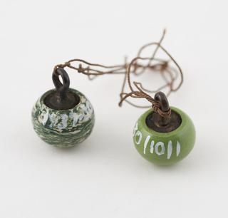 Two spherical buttons of green Parkesine