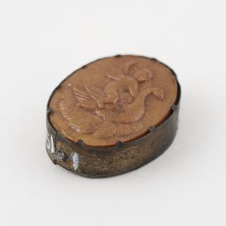 Decorated Parkesine medallion in metal holder