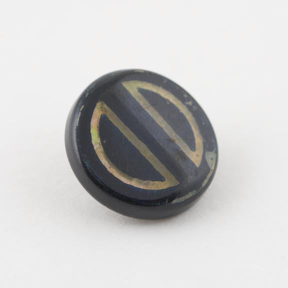 Circular celluloid covered steel button