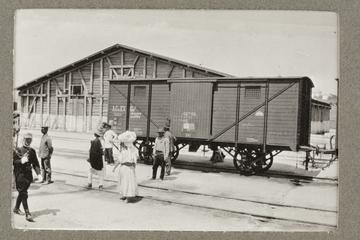 Untitled black and white photograph showing a rail wagon in front of a wooden building at Constanza port