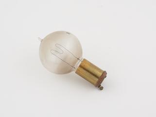 One of eighty-six early incandescent lamps.  M-shaped round