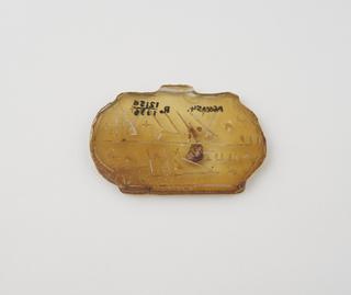 Plaque like amuletic pendant of glass