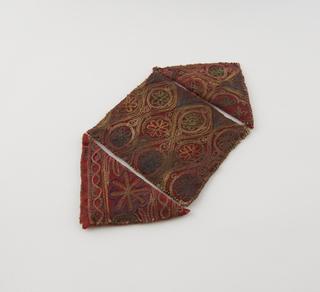 Square shaped cloth amulet with triangular side flaps