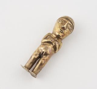 Gold statue depicting a female with long hair and her hands resting on her chest