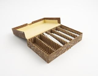 Four unsealed empty metal tubes for ointment