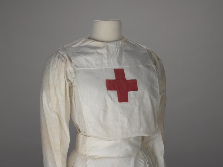 White cotton apron with a red cross