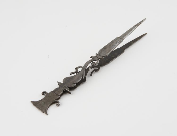 Steel tweezers with ornate shaped handle, for lifting weights