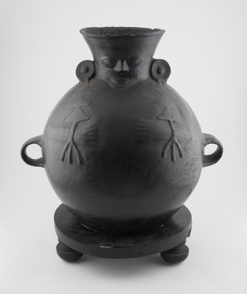 Black pottery water vessel, human face moulded on neck