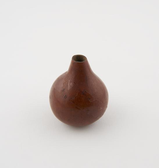 Small globe-shaped polished gourd container from South