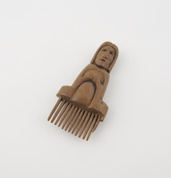 Comb or warp beater with handle in form of human female (?)