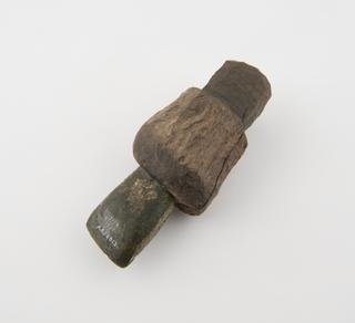 Polished stone axehead in stag antler holder