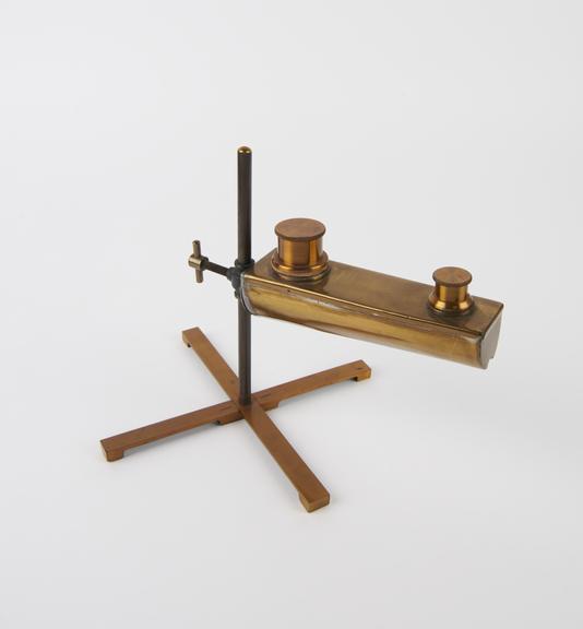 Blowpipe oil lamp on stand.