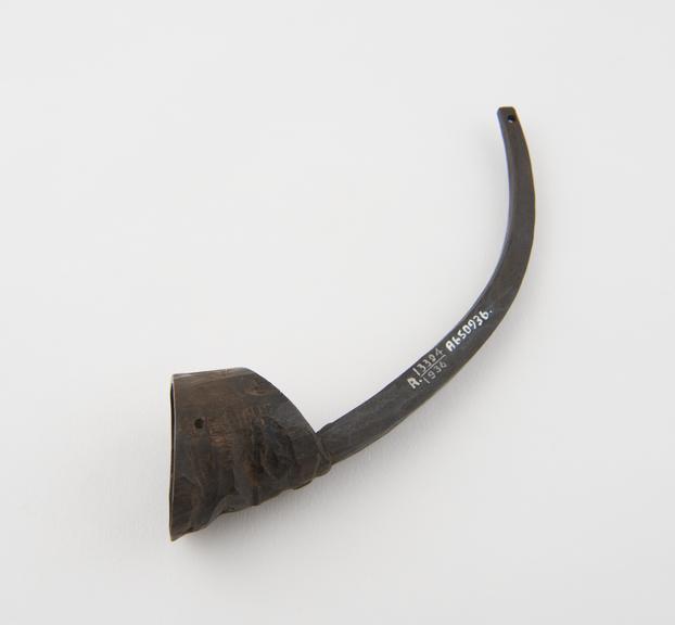 Carved horn head with long spur rising from forehead