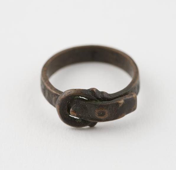 Bronze finger ring, in the form of a strap and buckle