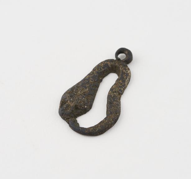 Amuletic pendant in form of bronze snake biting its tail,