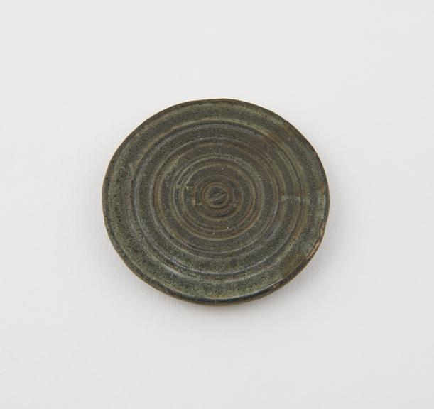 Bronze(?) disc, obverse covered with concentric grooved circles