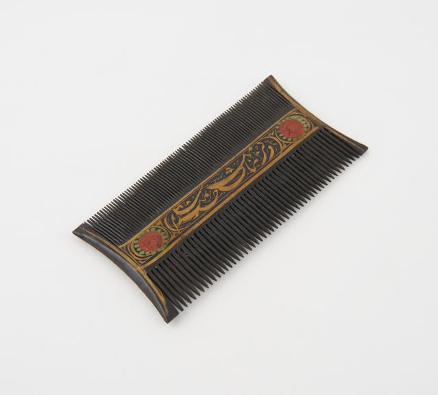 Double-sided black lacquer comb with centre panels decorated