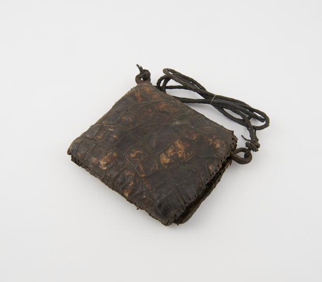 Amulet case made of crocodile skin and metal rod to which