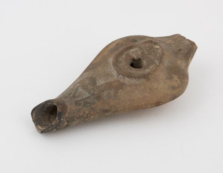 Grecian pottery oil lamp. Handle missing