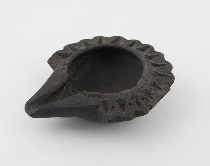 Black pottery lipped dish, ornamental border, no mark