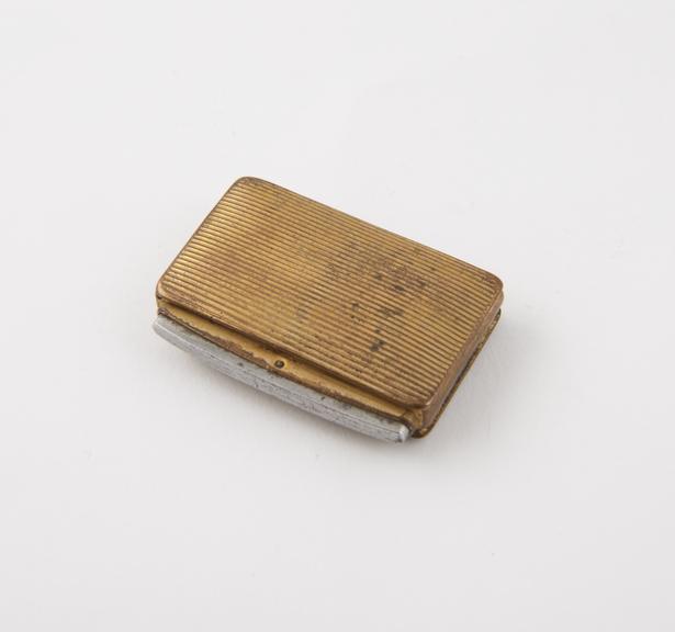 Tinder-box (length 1 5/8 in) of copper gilt; rectangular