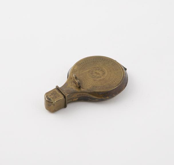 A Lighter (length 2 1/4 ins) of brass; round and flat-sided