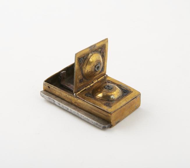 Tinder-box (length 1 5/8 in) of brass gilt; rectangular