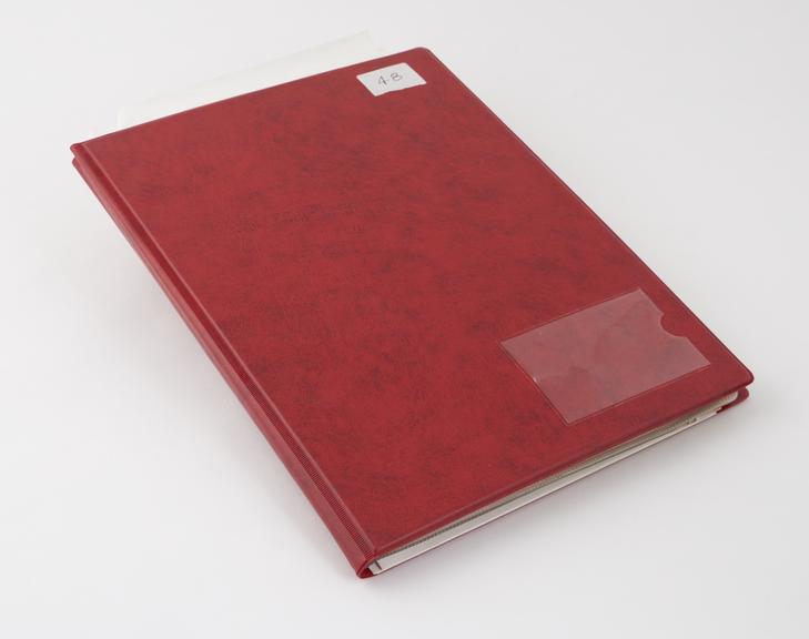 Transparent envelope binder containing photographs of