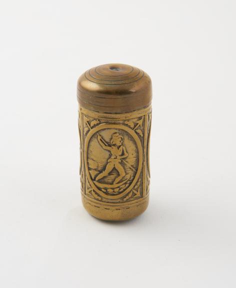 Tinder-tube (length 2 1/4 ins) of brass; surface embossed with