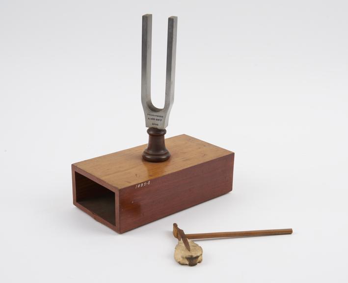 Standard 'A' tuning fork and hammer, on stand.