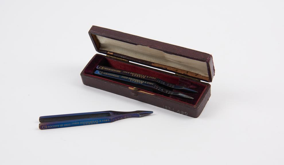 Three tuning forks, in leather case