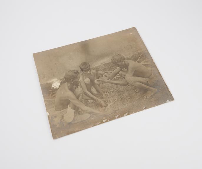 Photograph of three Natives of India making fire with a simple