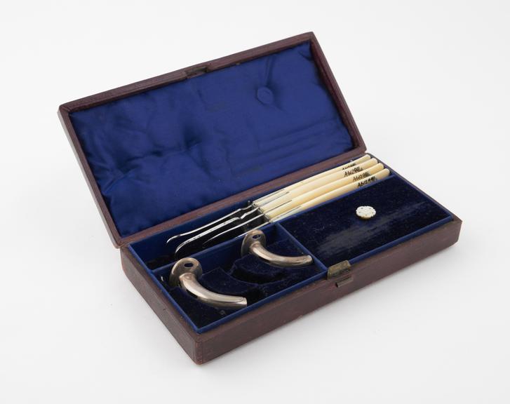 Tracheotomy instrument set, in red leather case