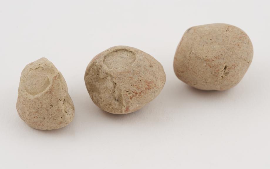 3 pieces of buff-coloured roughly spherical, terra sigillata