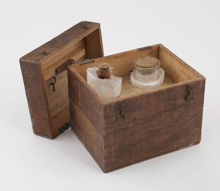 Accessories for Jean's oleorefractometer comprising a wooden box containing brass valves and clamps