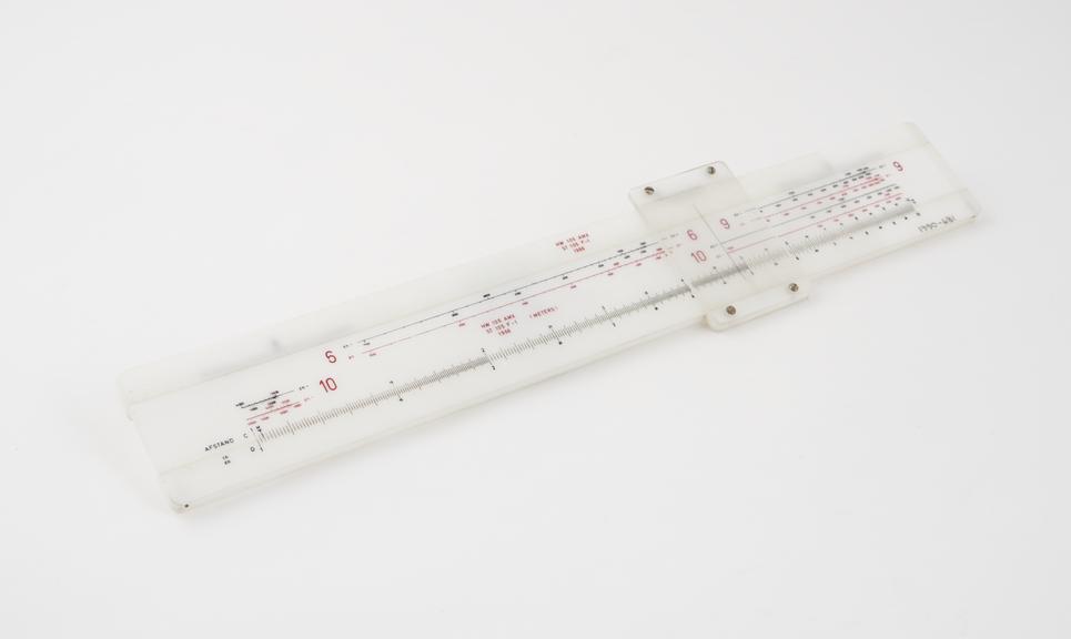 One of three Dutch slide rules, plastic, for artillery use.